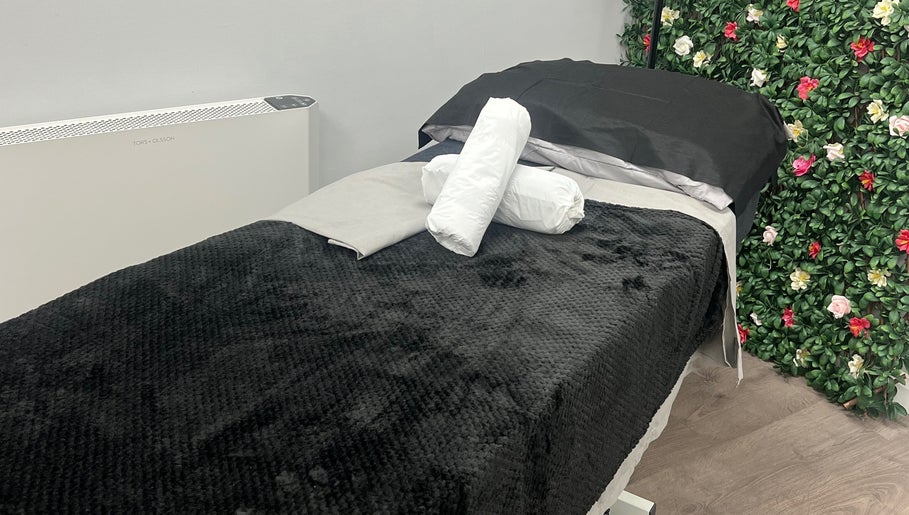 Relaxing treatment bed at Get Em Treatments, Aberdeen, Scotland, GB, surrounded by floral decor.