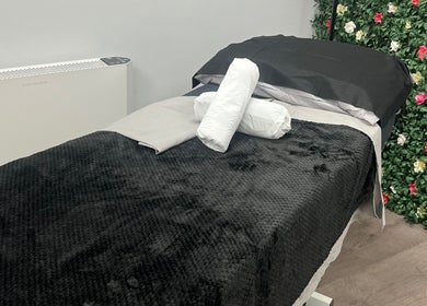 Relaxing treatment bed at Get Em Treatments, Aberdeen, Scotland, GB, surrounded by floral decor.