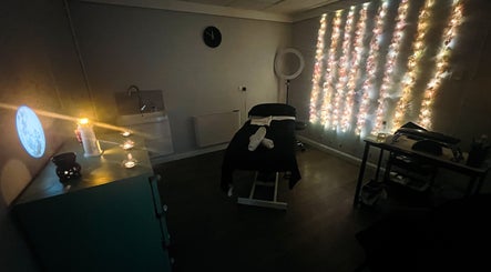 Relaxing treatment room at Get Em Treatments, Aberdeen, Scotland, GB with ambient lighting and treatment bed.