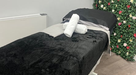 Relaxing massage bed with floral decor at Get Em Treatments, Aberdeen, Scotland, GB.