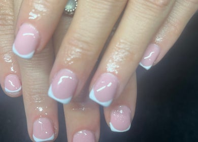 Close-up of French manicure at Nailed It, Darlington, England, GB, showcasing glossy pink nails with white tips.