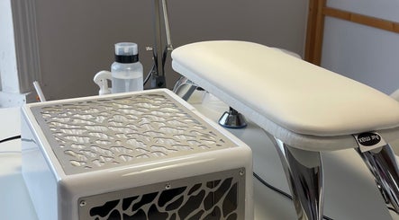 Elegant manicure station at NailEdit Studio, Dublin, IE, featuring modern tools and a sleek white design.