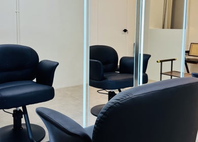 Elegant salon chairs at Tony Walker Hair Studio, Geylang Bahru MRT, SG, reflecting a modern, stylish ambiance.