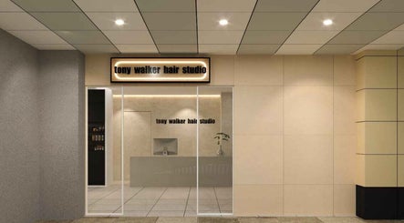 Elegant entrance of Tony Walker Hair Studio at Geylang Bahru MRT, SG, featuring modern design.