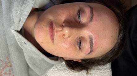 Relaxed client enjoying a facial treatment at MUGG'D, Ponteland, England, GB, highlighting fresh skin and eyebrows.