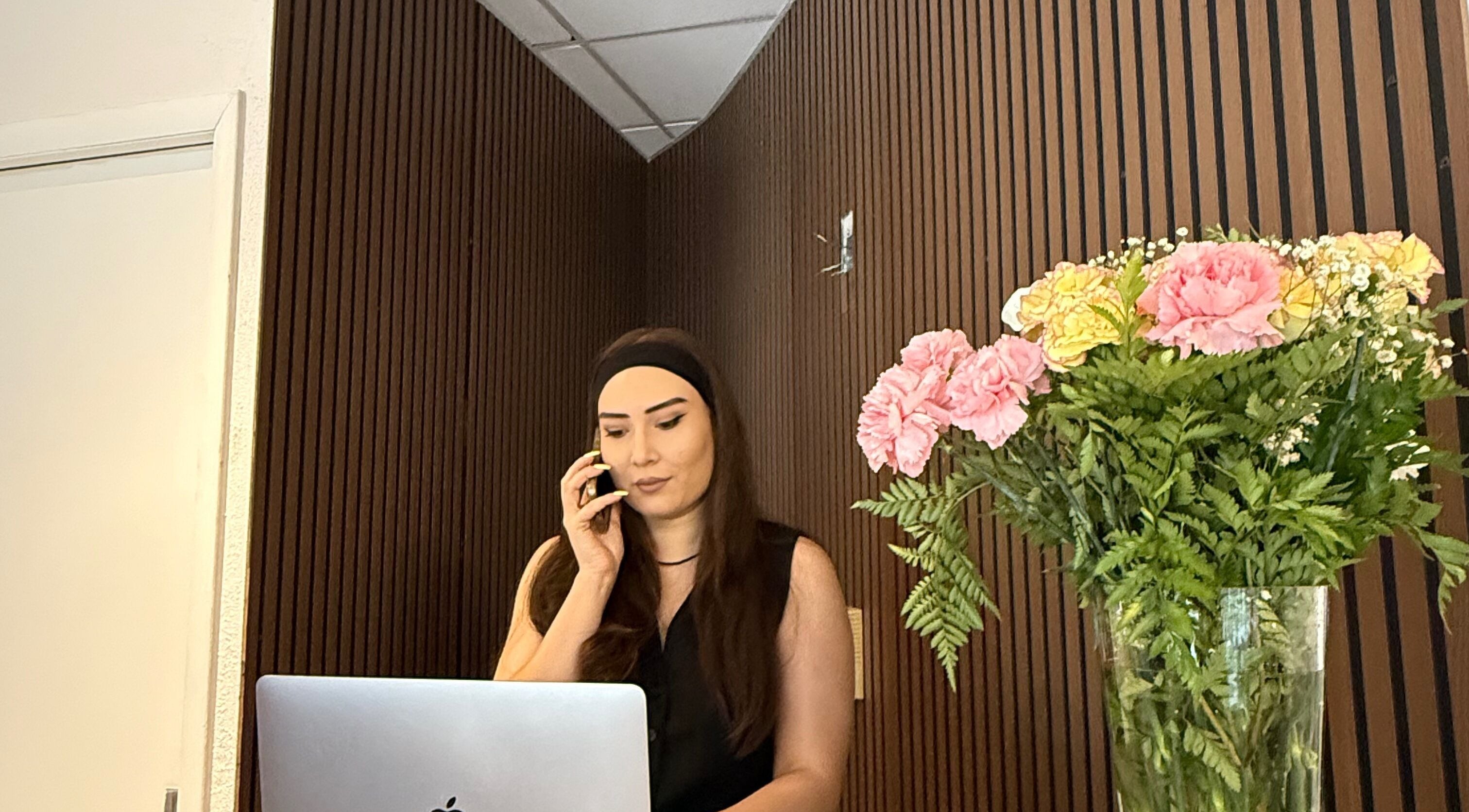 Reception area at 360 Beauty Studio, New York, New York, US, featuring a staff member on the phone.