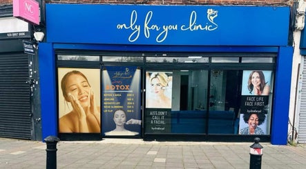 Exterior of Only For You Clinic in Perivale, England, GB showcasing beauty service posters.