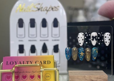 Elegant nail designs at Manpreet Nail Studio, London, England, GB with loyalty card displayed.