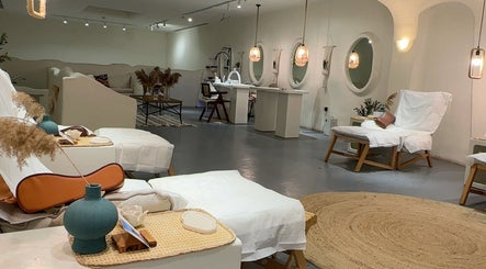 Elegant interiors of Oia Spa, Al Hofuf, Eastern Province, SA, featuring relaxing treatment chairs and soft lighting.