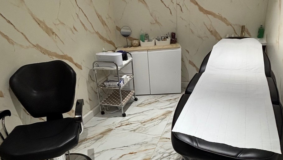 Elegant treatment room at USA Star Beauty, London, England, GB with chic black chair and massage table.