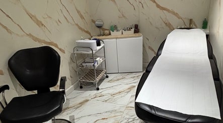 Elegant treatment room at USA Star Beauty, London, England, GB with chic black chair and massage table.