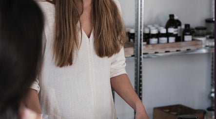 Staff arranging products at Cape of Storms Apothecary, Cape Town, Western Cape, ZA.