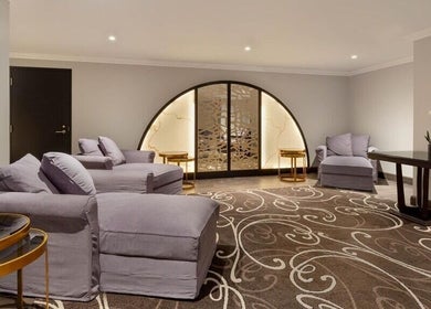 Relaxing lounge at Wellness 360 Spa At Hotel Retlaw, Fond Du Lac, Wisconsin, US with plush seating and decor.