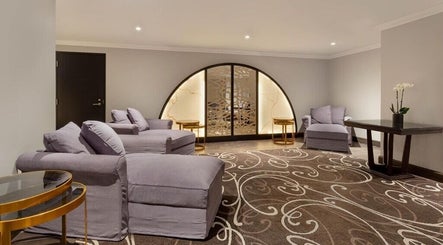 Relaxing lounge at Wellness 360 Spa At Hotel Retlaw, Fond Du Lac, Wisconsin, US with plush seating and decor.