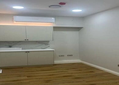 Modern wellness space at Made vas, London, England, GB, featuring wooden flooring and ambient lighting.