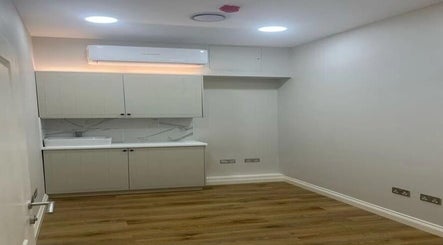 Modern wellness space at Made vas, London, England, GB, featuring wooden flooring and ambient lighting.