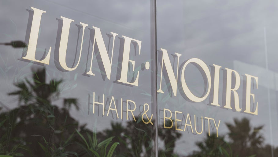 Lune Noire's elegant glass facade at Ir-rabat Għawdex, MT, showcasing the salon's sophistication.
