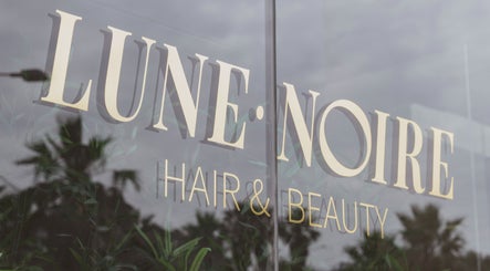 Lune Noire's elegant glass facade at Ir-rabat Għawdex, MT, showcasing the salon's sophistication.