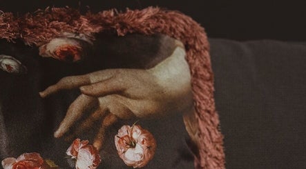 Detailed floral cushion with artful hands at Lune Noire, Ir-rabat Għawdex, MT.
