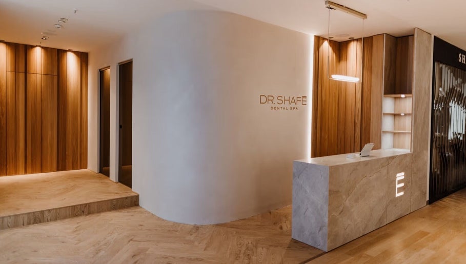 Eleganter Empfangsbereich bei DR. SHAFÉ Dental Spa GmbH in Berlin, Berlin, DE mit moderner Holzoptik.