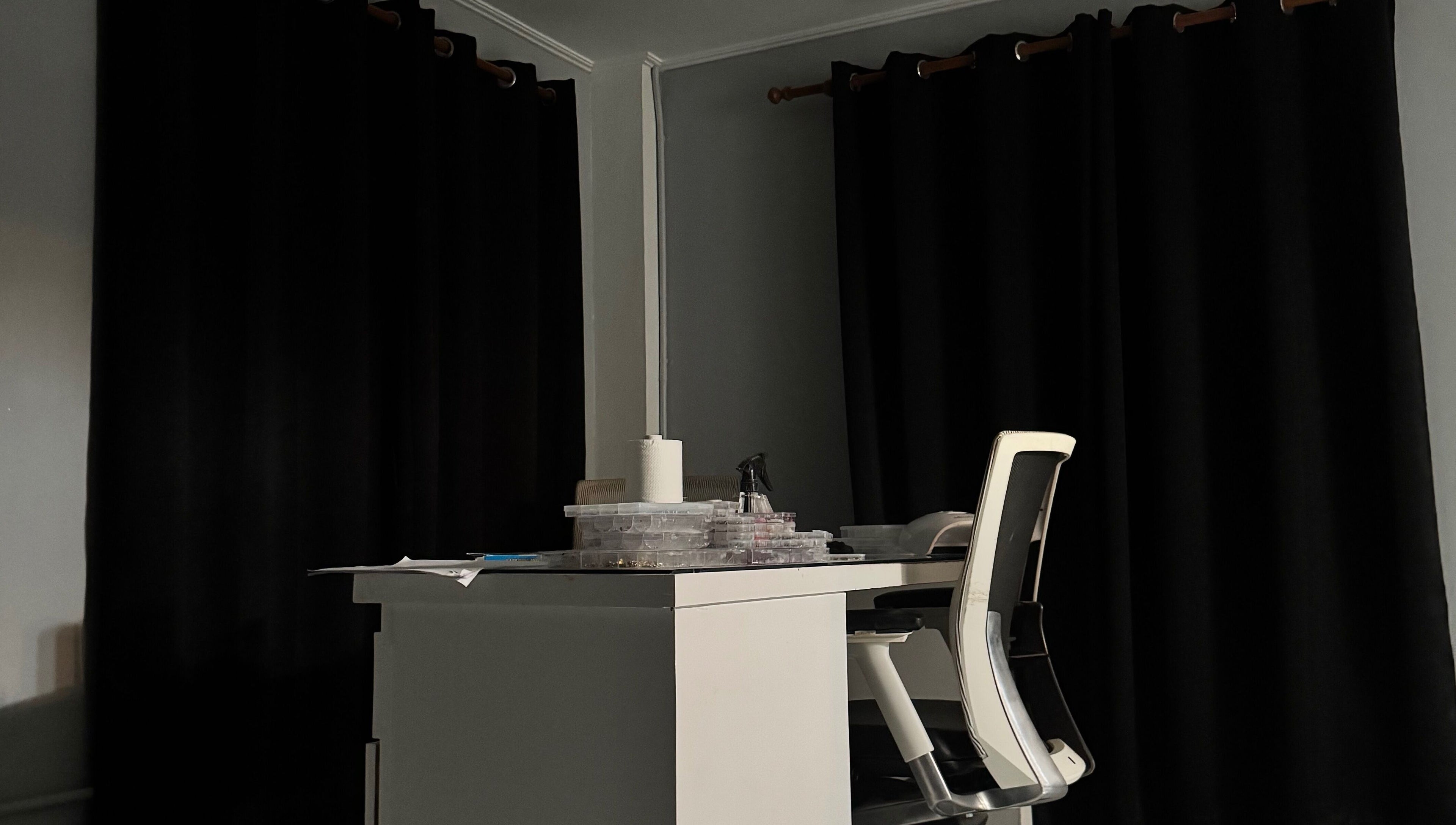 Cozy nail desk at Crystancianailedit in Halton, Saint Philip, BB, with black curtains and chic chair.