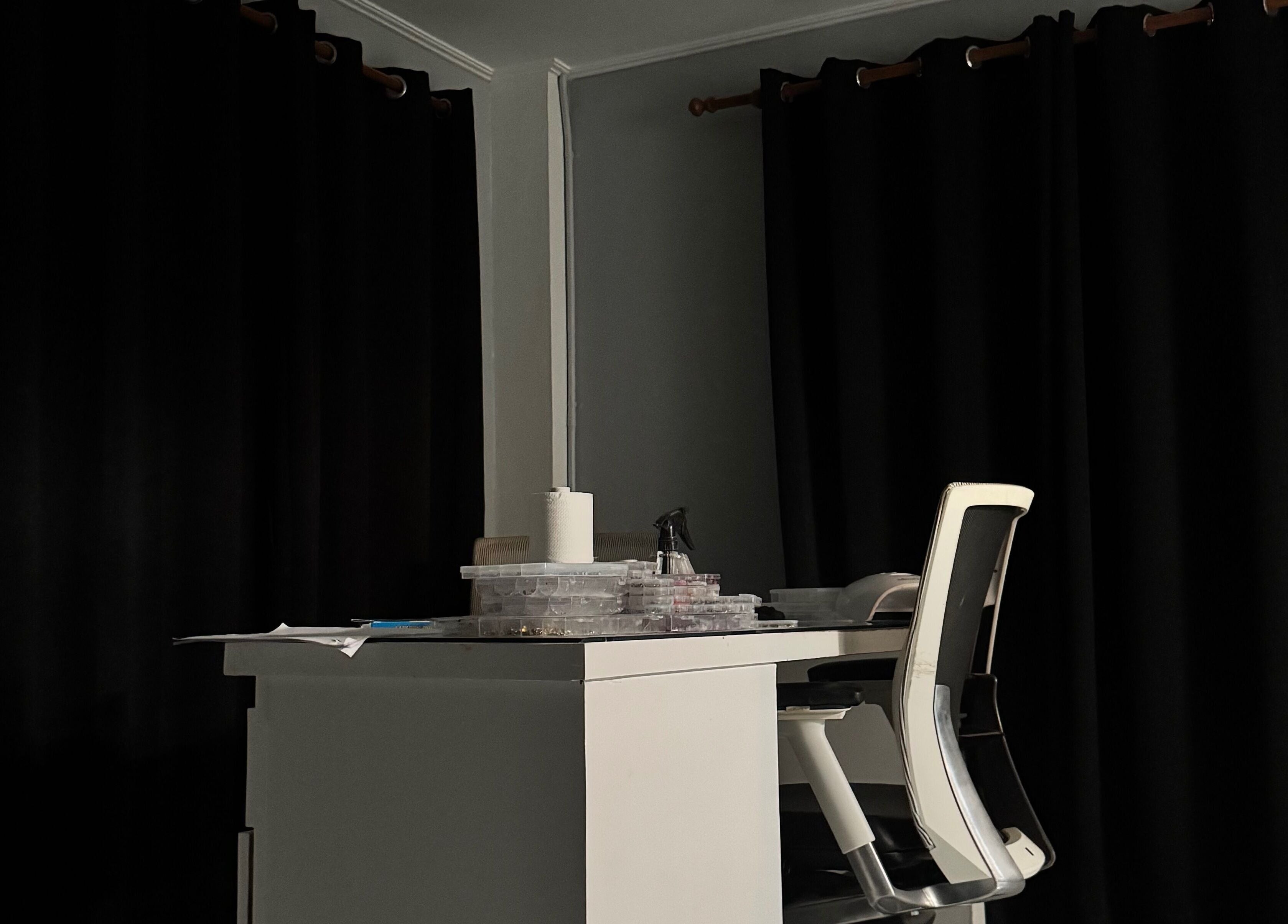 Cozy nail desk at Crystancianailedit in Halton, Saint Philip, BB, with black curtains and chic chair.