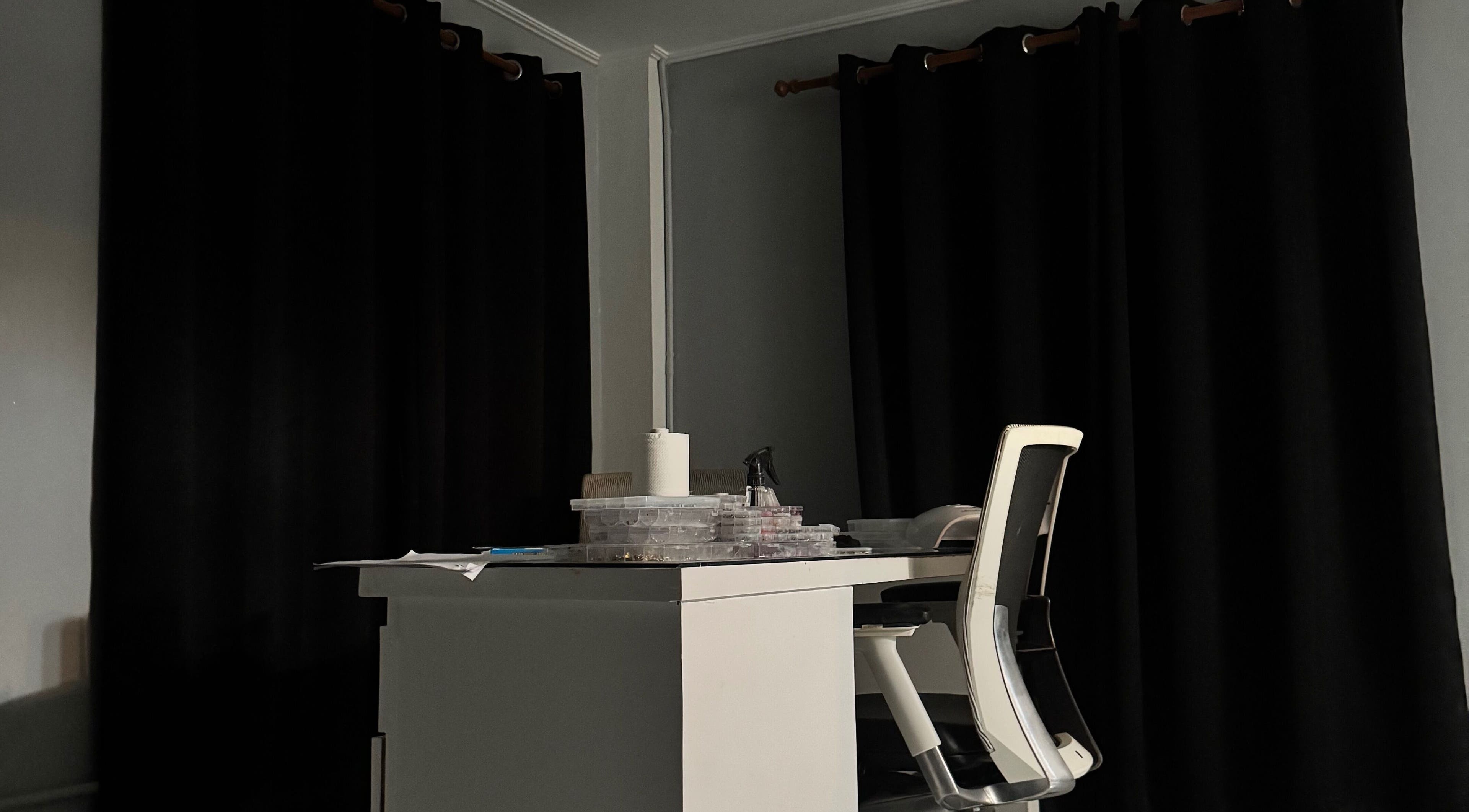 Cozy nail desk at Crystancianailedit in Halton, Saint Philip, BB, with black curtains and chic chair.