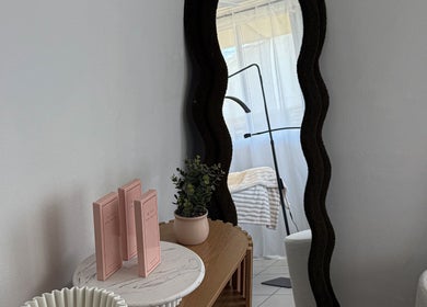 Chic interior view of Arch Aesthetic Co., Palm Beach, Queensland, AU with elegant mirror and decor.