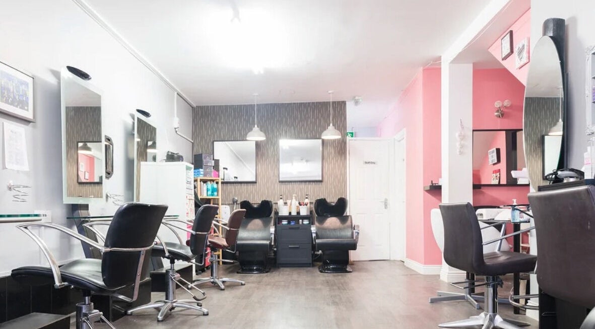 Bright interior of Royal Key Salon in Toronto, Ontario, CA featuring stylish chairs and mirrors.