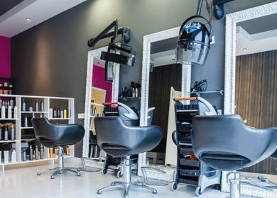 Modern salon interior at Royal Key Salon in Toronto, Ontario, CA, featuring stylish chairs and mirrors.