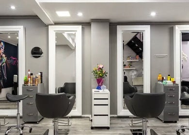 Modern salon interior at Royal Key Salon, Toronto, Ontario, CA, featuring sleek chairs and mirrors.