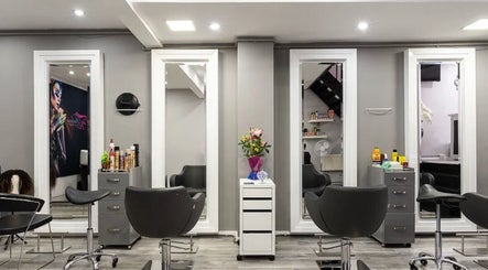 Modern salon interior at Royal Key Salon, Toronto, Ontario, CA, featuring sleek chairs and mirrors.