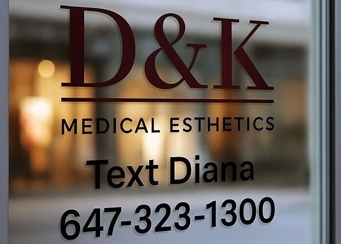 Entrance sign of D&K Medical Esthetics in Grimsby, Ontario, CA showcasing contact info.