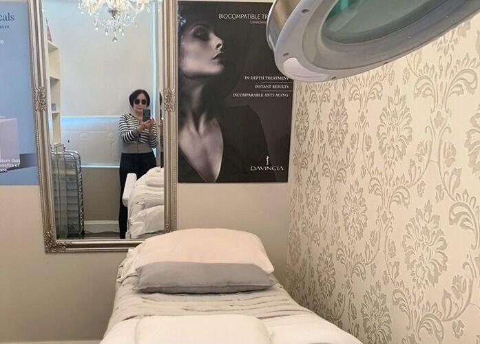 Luxurious treatment room at D&K Medical Esthetics in Grimsby, Ontario, CA showcasing elegant decor and skincare products.