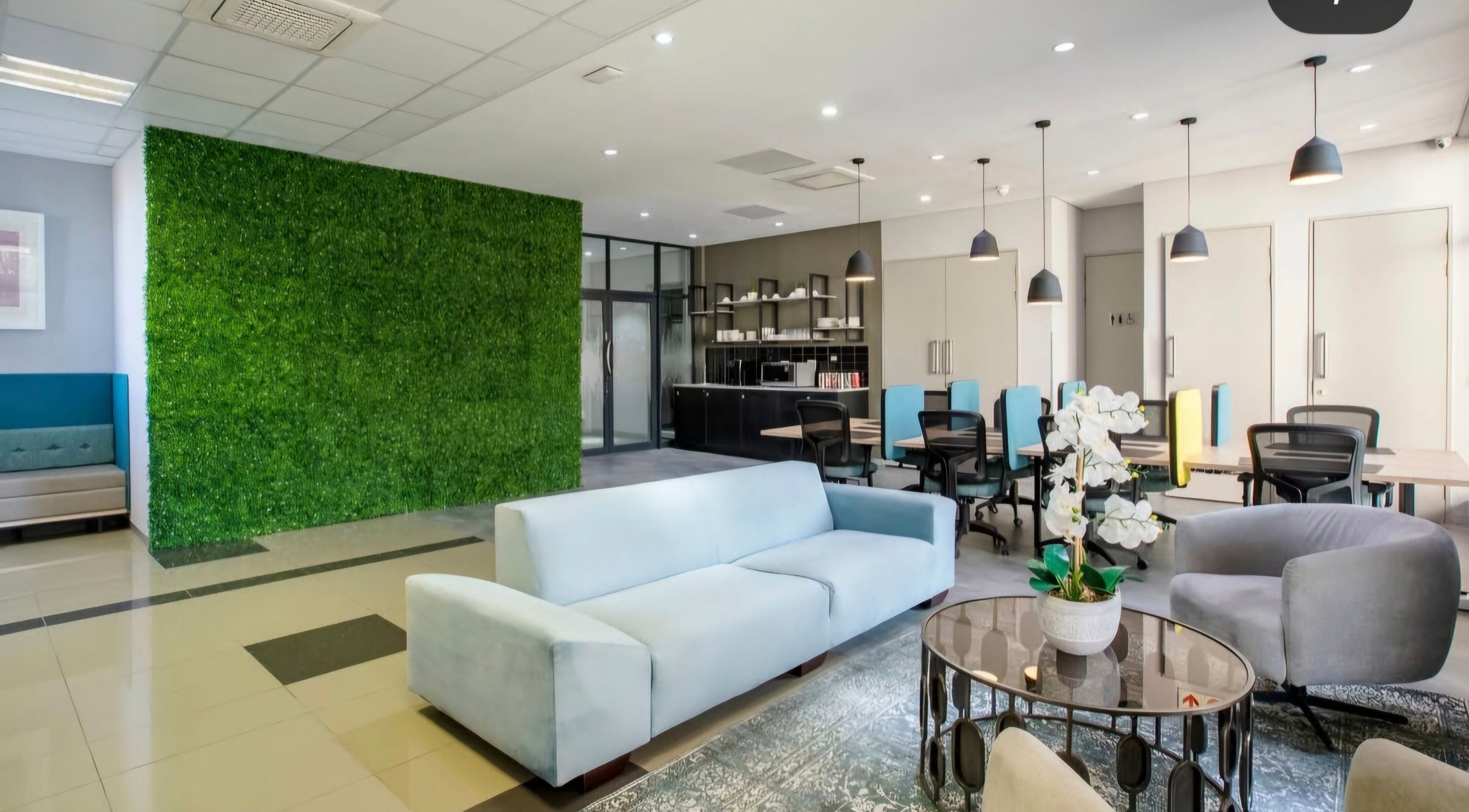 Modern lounge at Déjà Vu Aesthetics, Sandton, Gauteng, ZA with green feature wall and sleek furnishings.