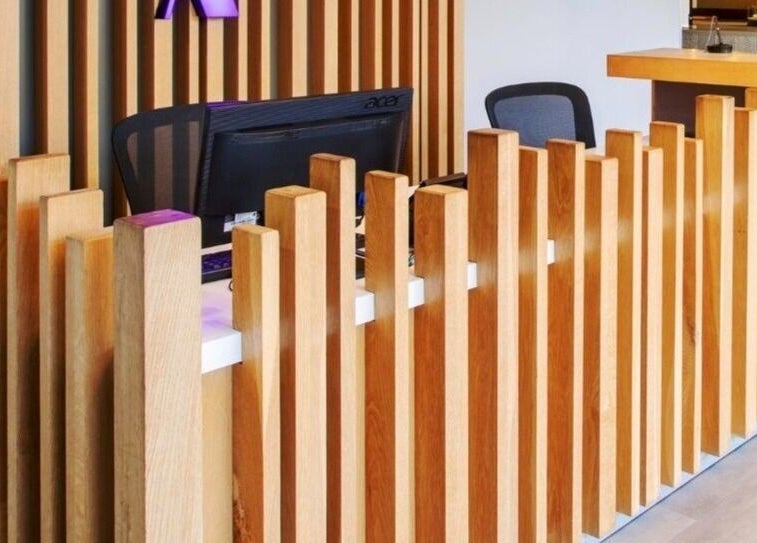 Modern wooden reception at Déjà Vu Aesthetics, Sandton, Gauteng, ZA showcasing stylish interior design.