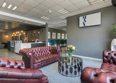 Luxurious lounge area at Déjà Vu Aesthetics, Sandton, Gauteng, ZA with leather sofas and chic decor.