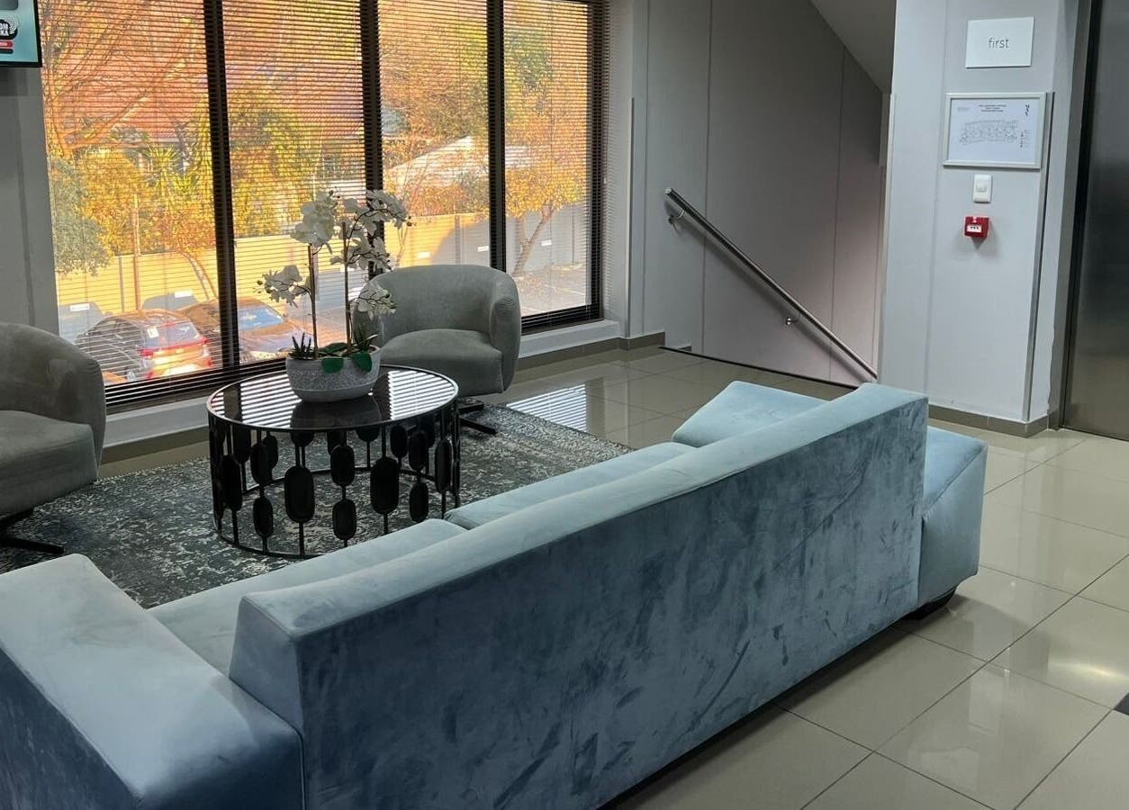 Elegant waiting area at Déjà Vu Aesthetics, Sandton, Gauteng, ZA with plush seating and natural light.
