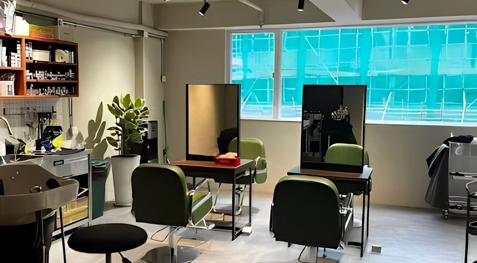 Modern interior of PEACH Japanese Hair Salon on Hong Kong Island, HK, showcasing green chairs and mirrors.