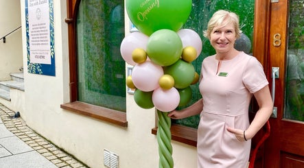 Warm welcome at Saltash Massage Therapy Zen with Zuzana, Saltash, England, GB. Smiling staff by green balloons.