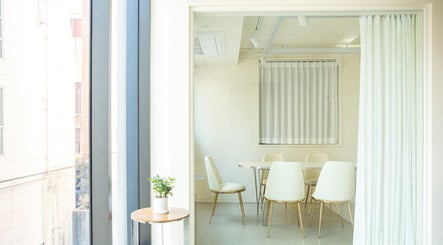 Bright meeting room at 비올 뷰티 BEALL BEAUTY, 서울특별시, Seoul, KR with white chairs and table.