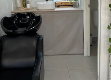 Elegant black salon chair and wash basin at JA Pro Beauty in Bundaberg West, Queensland, AU.