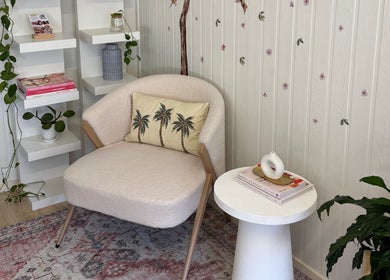 Elegant seating area at JA Pro Beauty, Bundaberg West, Queensland, AU. Features comfy chair, chic decor, and plant.