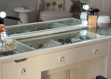 Elegant makeup station at JA Pro Beauty in Bundaberg West, Queensland, AU featuring a chic, mirror-lit vanity.