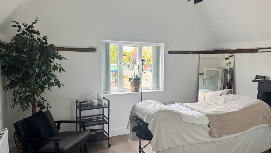 Relaxing treatment room at The Soul Co at Curlita Beauty in Stafford, England, GB, with cozy decor and natural light.