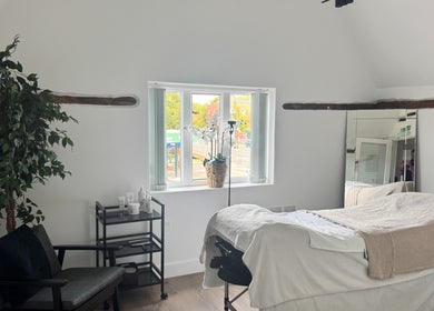 Relaxing treatment room at The Soul Co at Curlita Beauty, Stafford, England, GB featuring a massage bed and decor.