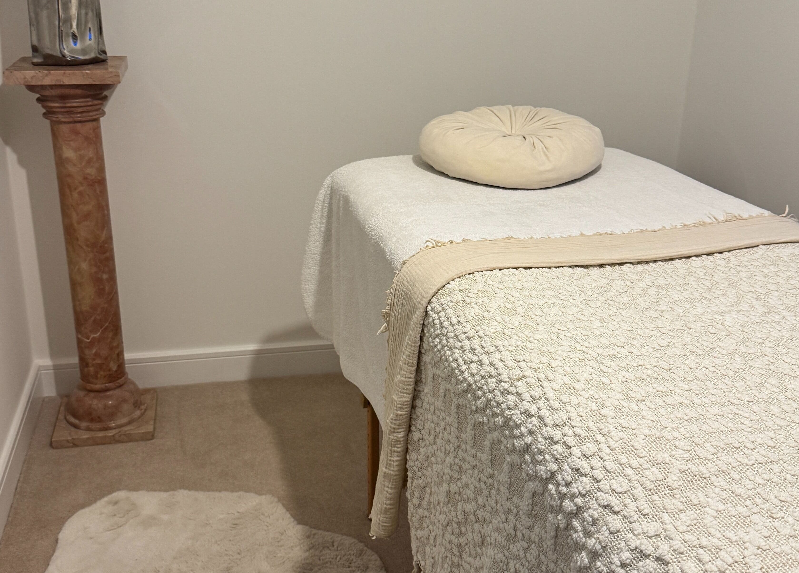 Relaxing massage room at The Soul Co - Warwickshire, Warwick, England, GB. Cozy setting with soothing tones.