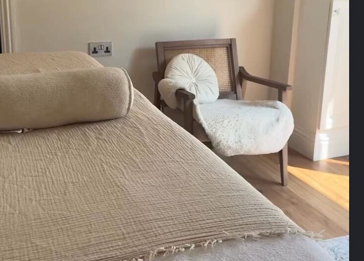 Relaxing wellness space at The Soul Co - Warwickshire in Warwick, England, GB, featuring a comfy chair and massage table.