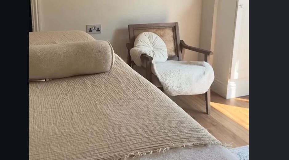 Relaxing wellness space at The Soul Co - Warwickshire in Warwick, England, GB, featuring a comfy chair and massage table.