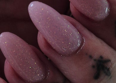 Sparkling manicure at Oliviabeautè, Eastbourne, England, GB showcases elegant, glittery nail design.